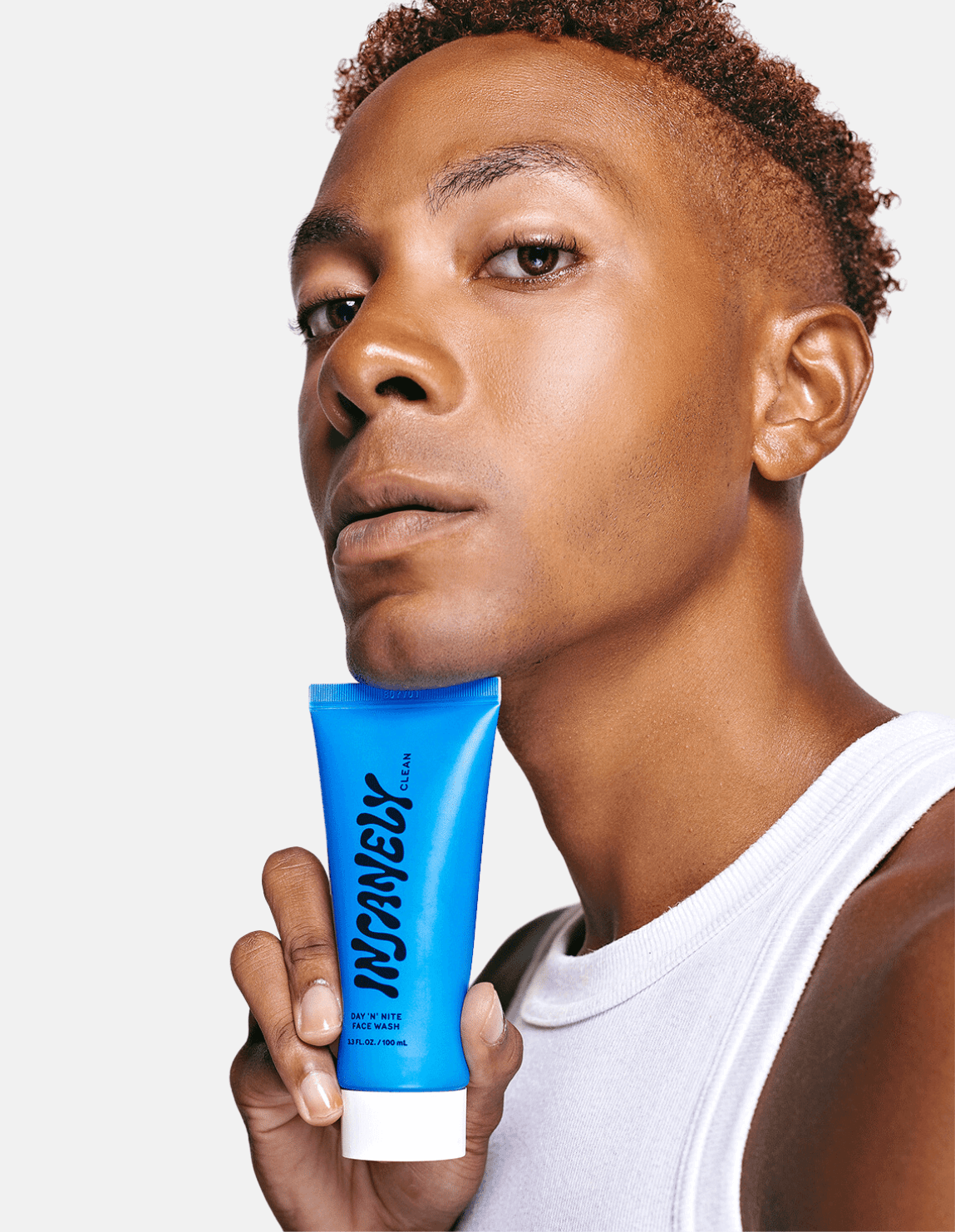 A man posing with the best deep cleansing face wash for men.