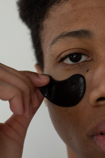 A man applying a skincare product to his male face, enhancing his complexion with the tailored skincare solutions for men.
