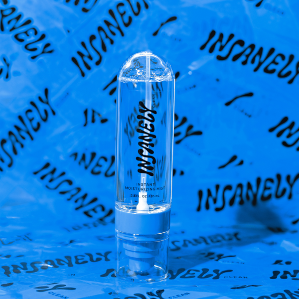 A close-up of Insanely Clean's Instant Moisturizing Mist 85mL set against a backdrop of blue tape adorned with the Insanely Clean logo.
