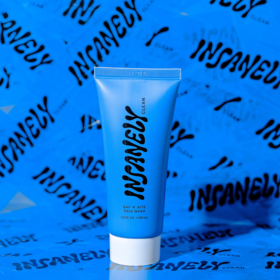 A close-up of Insanely Clean's Day 'n' Nite Face Wash set against a background covered in Insanely Clean tape.