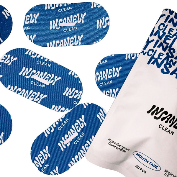 A close-up of several strips inside the Insanely Clean Mouth Tape package, designed to energize, control snoring, and enhance your profile naturally—ensuring a peaceful night's sleep.