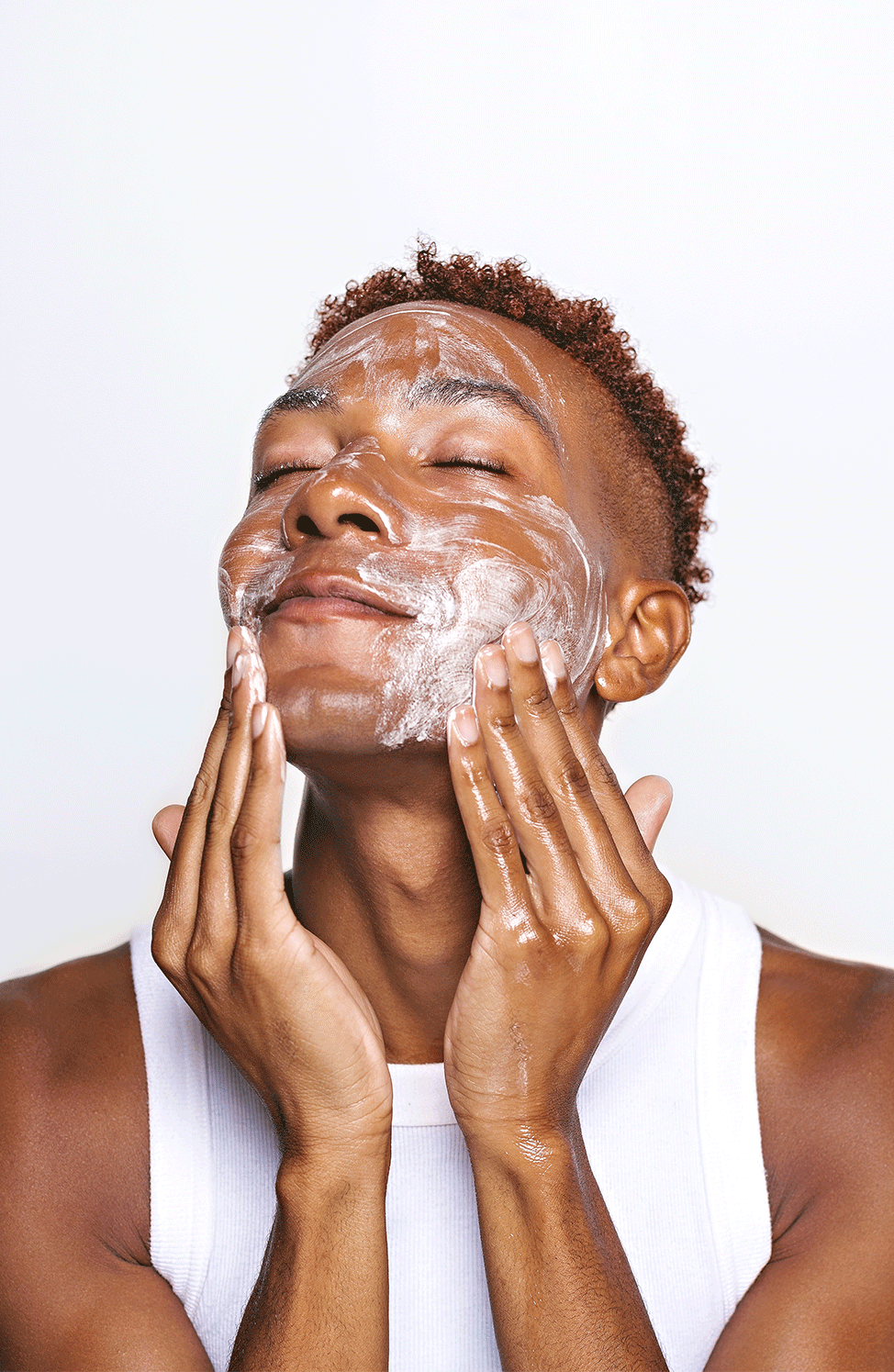 A man scrubbing his face with Insanely Clean's Day 'N" Nite Face Wash.