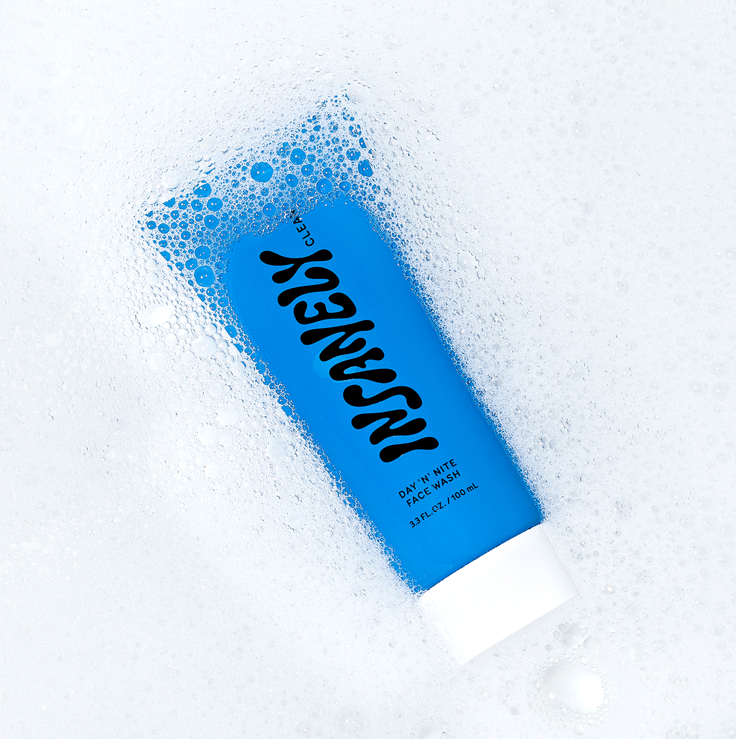 The best natural face wash for men that delivers glowing skin for men floating in a pool of bubbles.