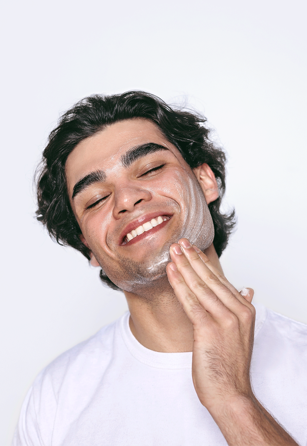 Young man washing his face with best-selling men's face wash.